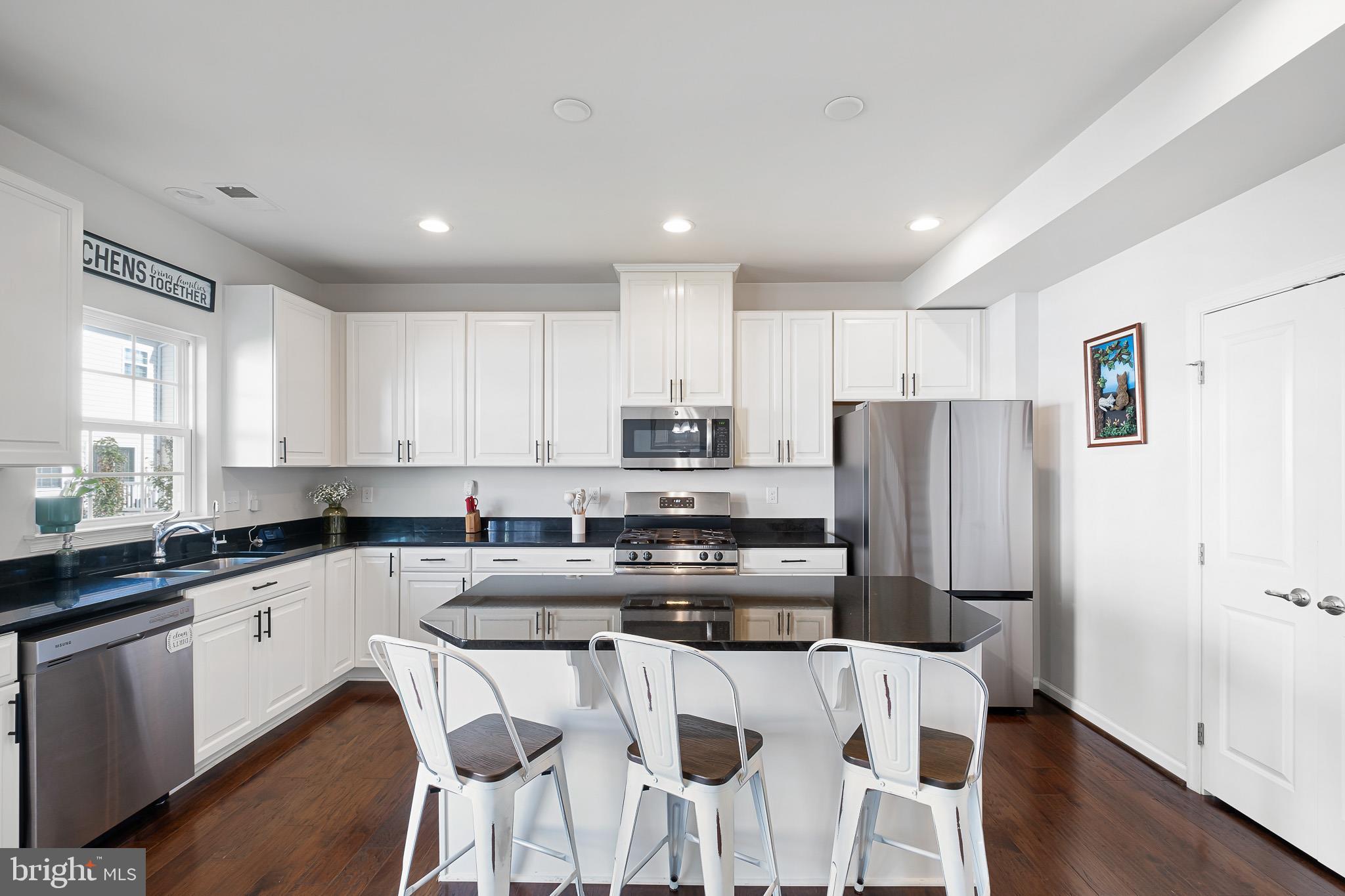 449 Smee Road Middletown, DE 19709 - Photo 10 of 31 a kitchen with stainless steel appliances granite countertop a refrigerator a stove a sink a dining table and chairs