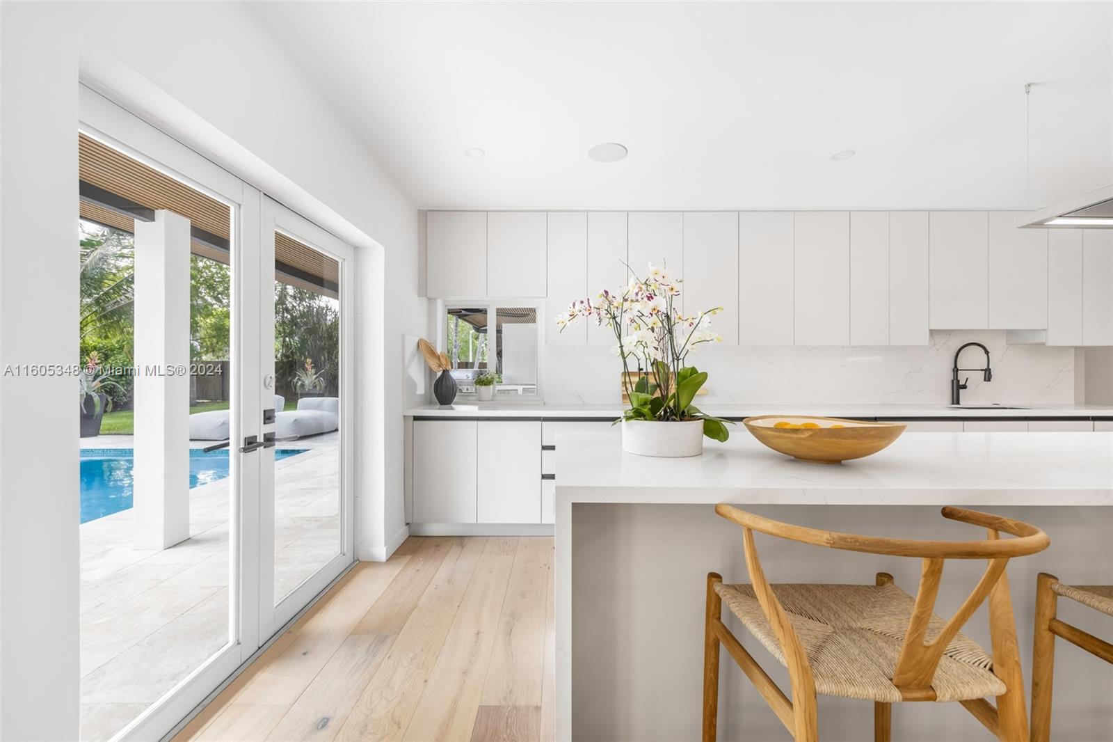 9800 Southwest 70th Avenue Pinecrest, FL 33156 - Photo 12 of 46 a kitchen with stainless steel appliances a sink a counter top space and a wooden floor
