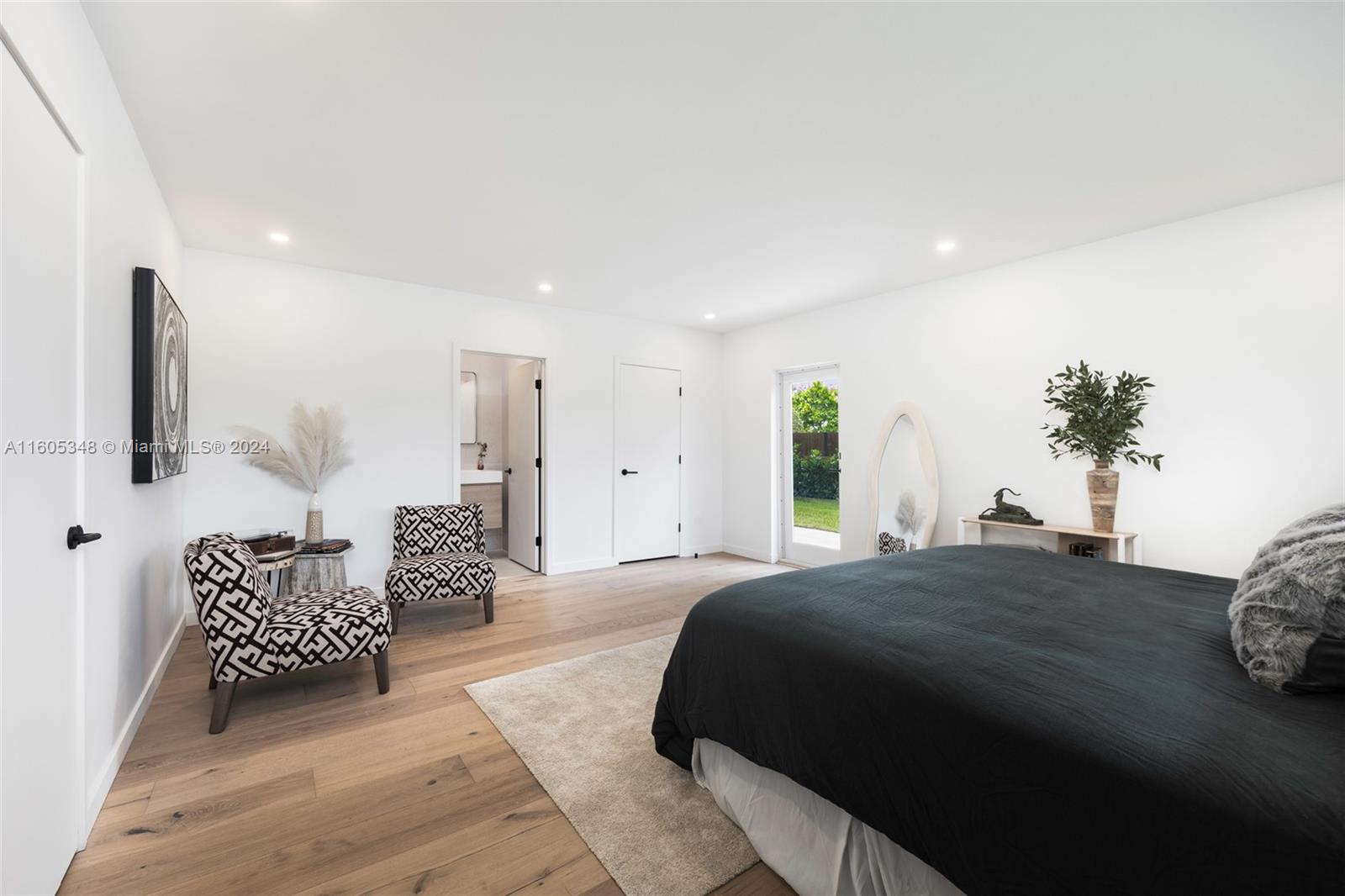 9800 Southwest 70th Avenue Pinecrest, FL 33156 - Photo 18 of 46 a spacious bedroom with a bed and a couch
