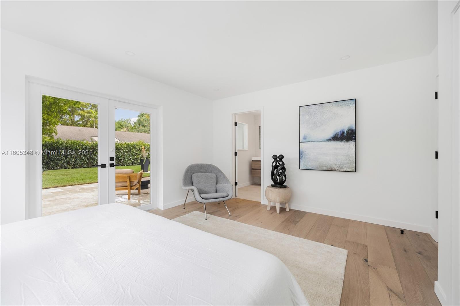 9800 Southwest 70th Avenue Pinecrest, FL 33156 - Photo 20 of 46 a bedroom with a bed and a large window