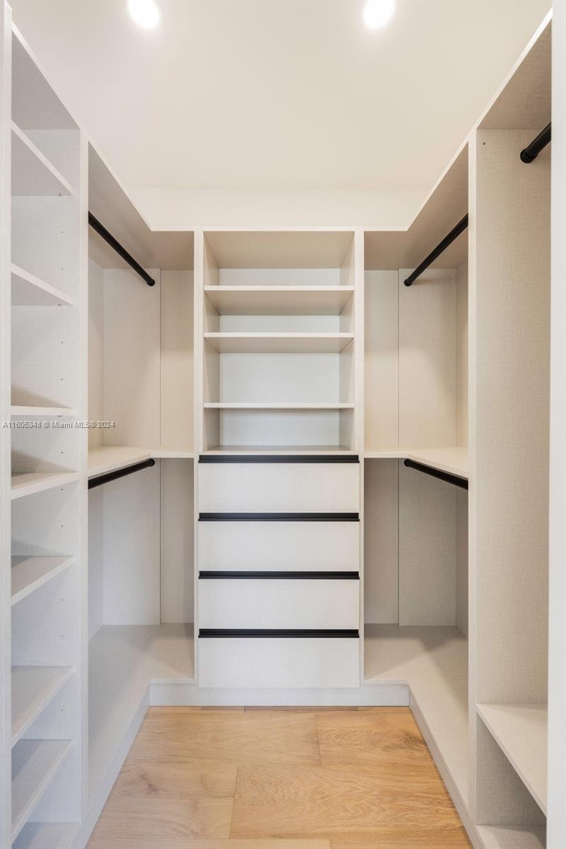 9800 Southwest 70th Avenue Pinecrest, FL 33156 - Photo 28 of 46 a view of walk in closet with empty racks