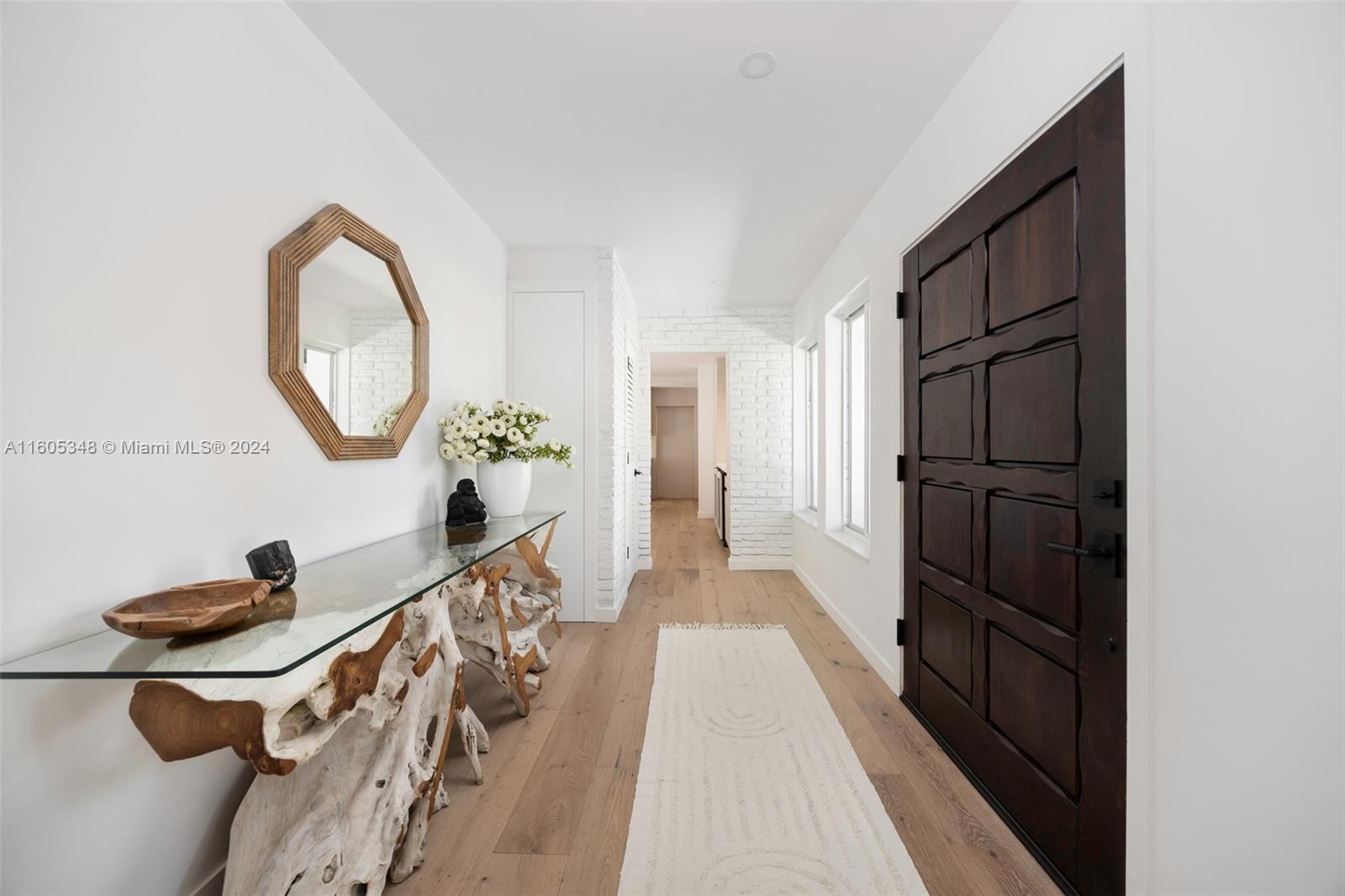 9800 Southwest 70th Avenue Pinecrest, FL 33156 - Photo 3 of 46 a very nice looking room with a large window and a chandelier