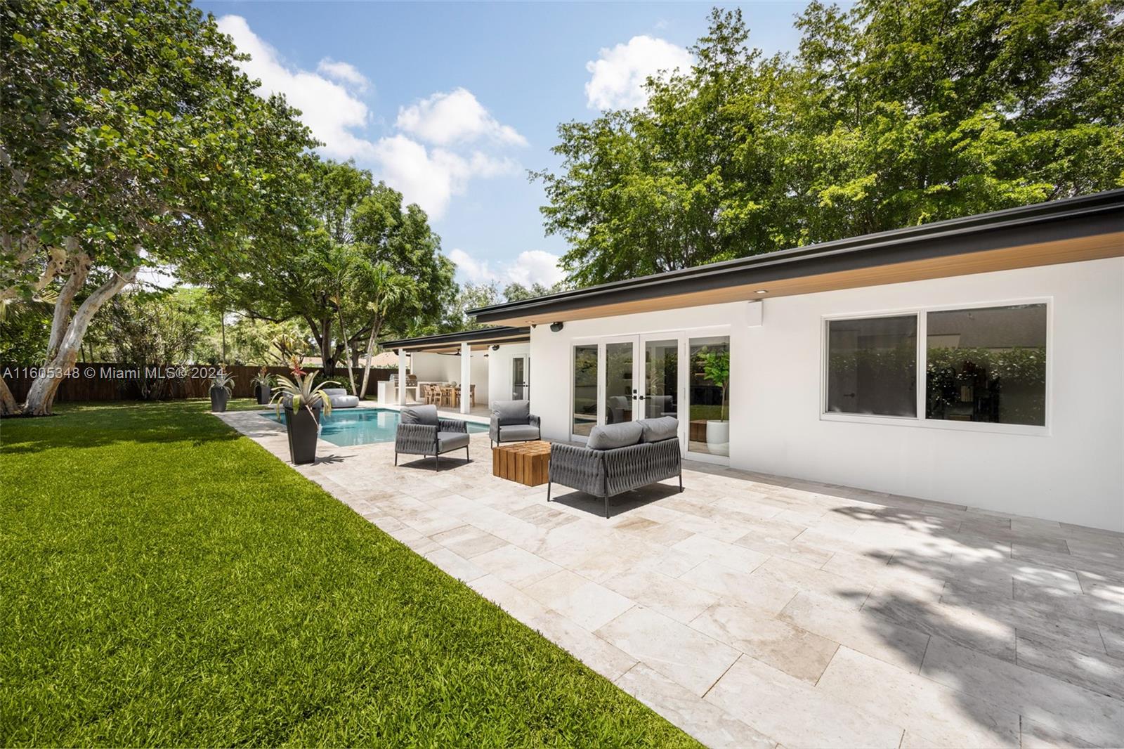 9800 Southwest 70th Avenue Pinecrest, FL 33156 - Photo 33 of 46 a view of a house with sitting area and garden