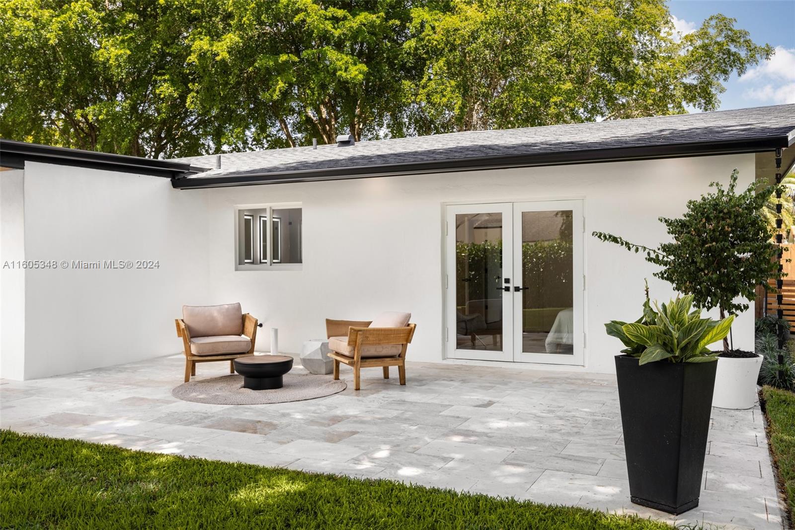 9800 Southwest 70th Avenue Pinecrest, FL 33156 - Photo 34 of 46 a backyard of a house with outdoor seating