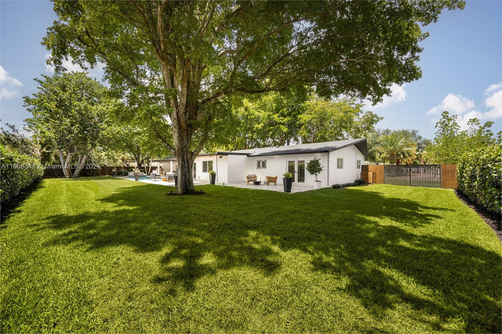 9800 Southwest 70th Avenue Pinecrest, FL 33156 - Photo 35 of 46 a front view of house with yard and green space