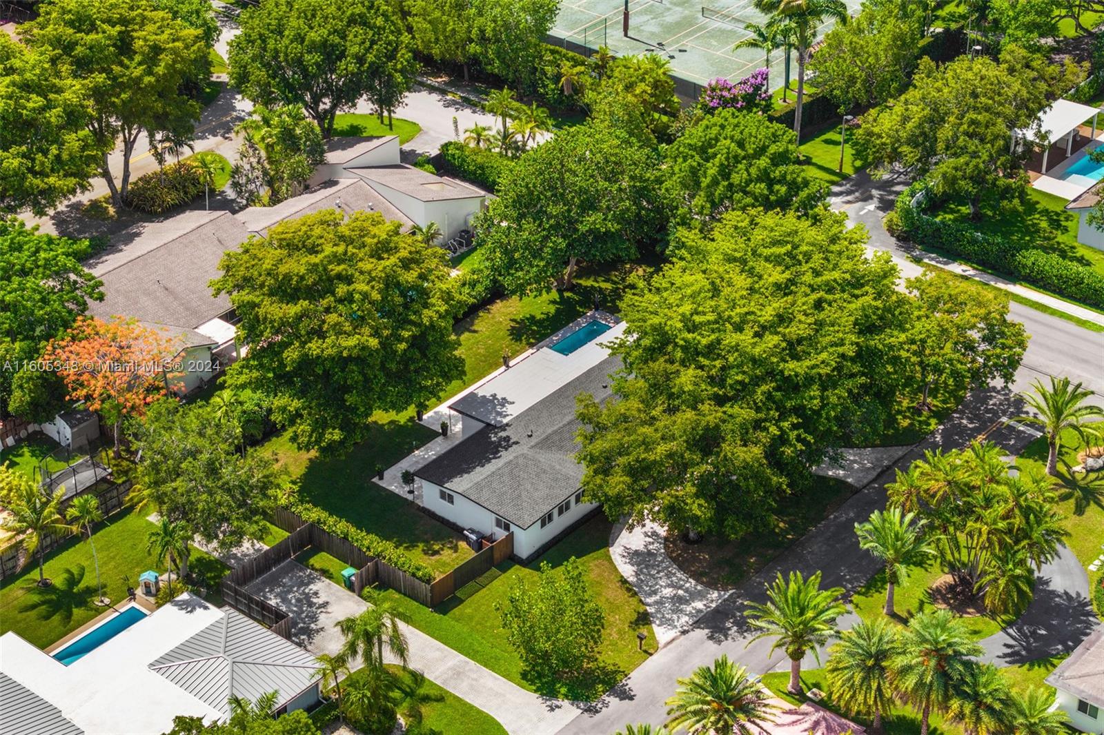 9800 Southwest 70th Avenue Pinecrest, FL 33156 - Photo 39 of 46 an aerial view of a house with a yard and trees