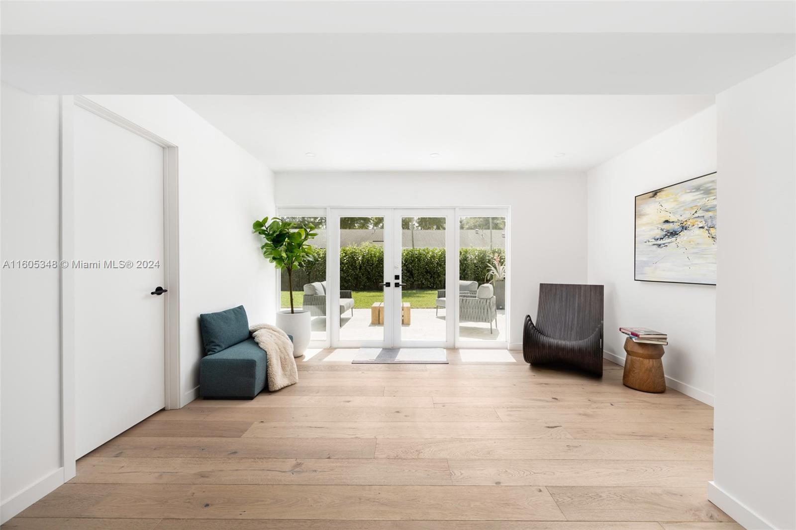 9800 Southwest 70th Avenue Pinecrest, FL 33156 - Photo 4 of 46 a living room with furniture and a large window