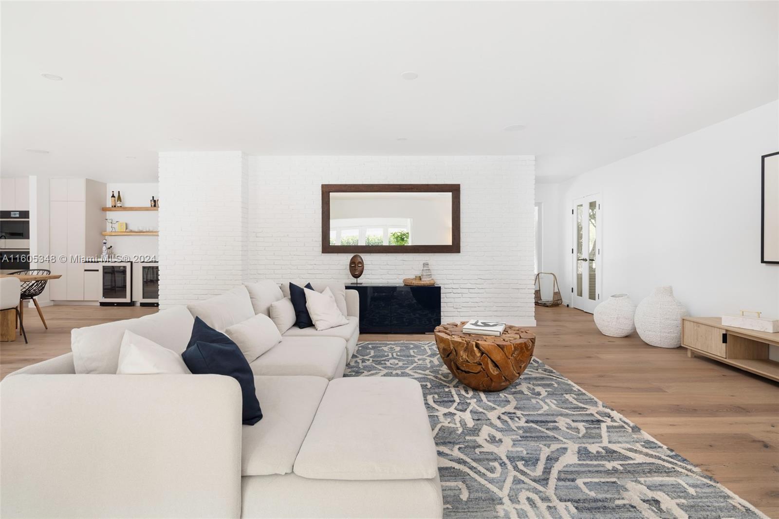 9800 Southwest 70th Avenue Pinecrest, FL 33156 - Photo 8 of 46 a living room with furniture a rug and a view of kitchen