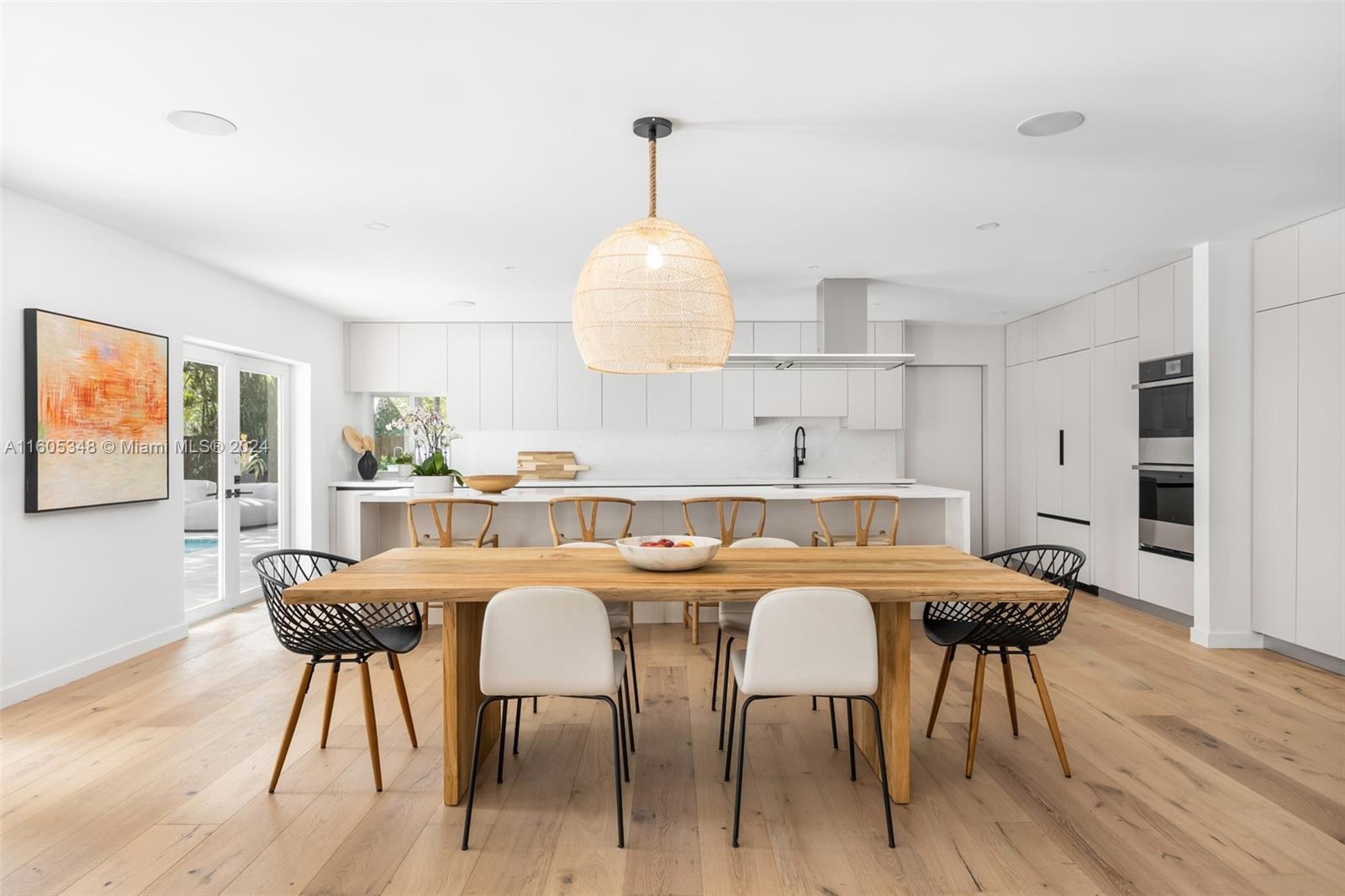 9800 Southwest 70th Avenue Pinecrest, FL 33156 - Photo 10 of 46 a kitchen that has a table and chairs in it