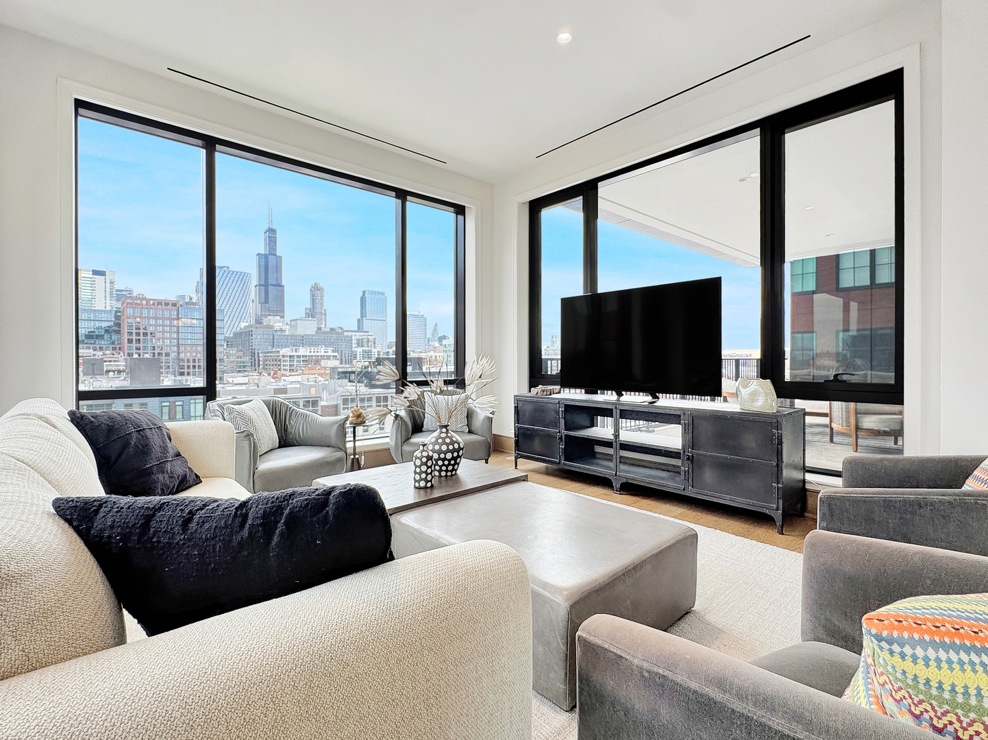21 North May Street, Unit 802 Chicago, IL 60607 - Photo 12 of 50 a living room with furniture and a flat screen tv