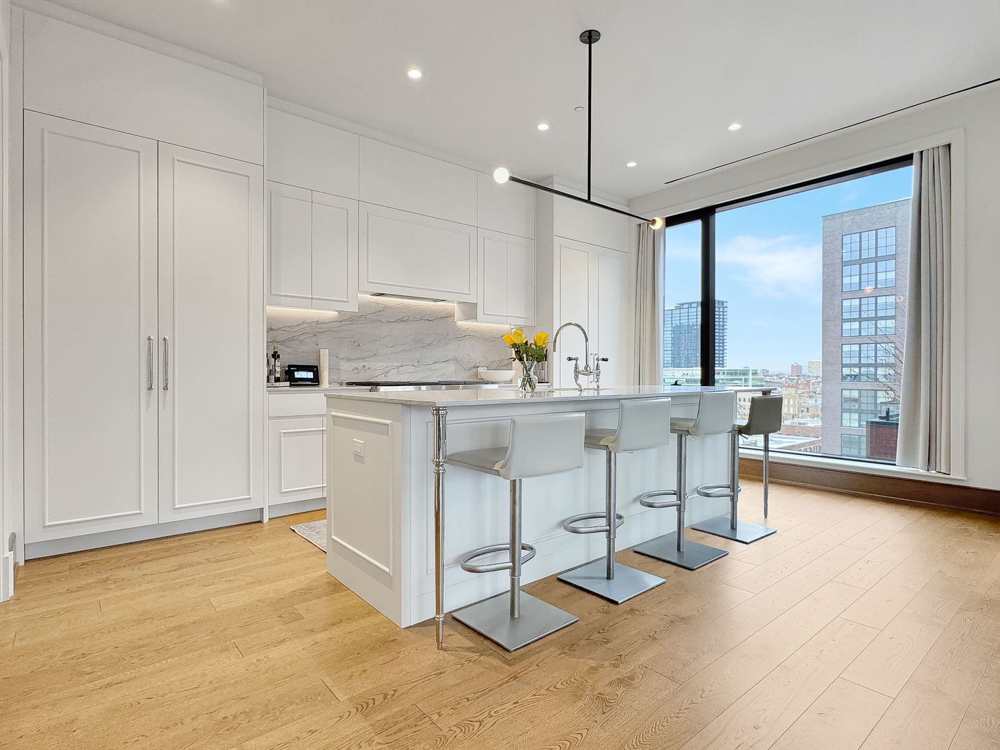 21 North May Street, Unit 802 Chicago, IL 60607 - Photo 15 of 50 a kitchen with appliances cabinets and a chair