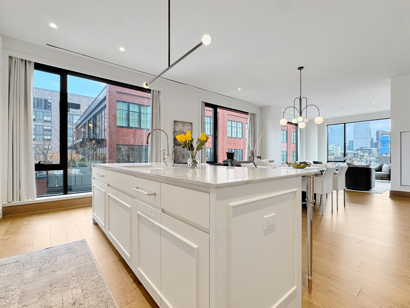 21 North May Street, Unit 802 Chicago, IL 60607 - Photo 17 of 50 a large kitchen with kitchen island a large counter top space a sink stainless steel appliances and cabinets