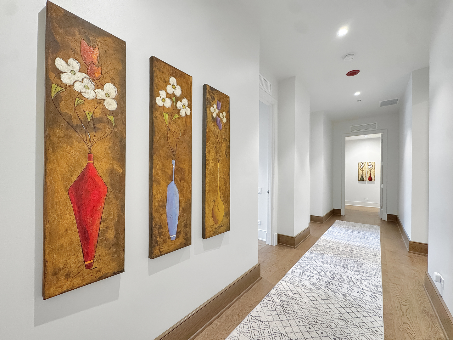 21 North May Street, Unit 802 Chicago, IL 60607 - Photo 19 of 50 a view of a hallway with paintings on the wall