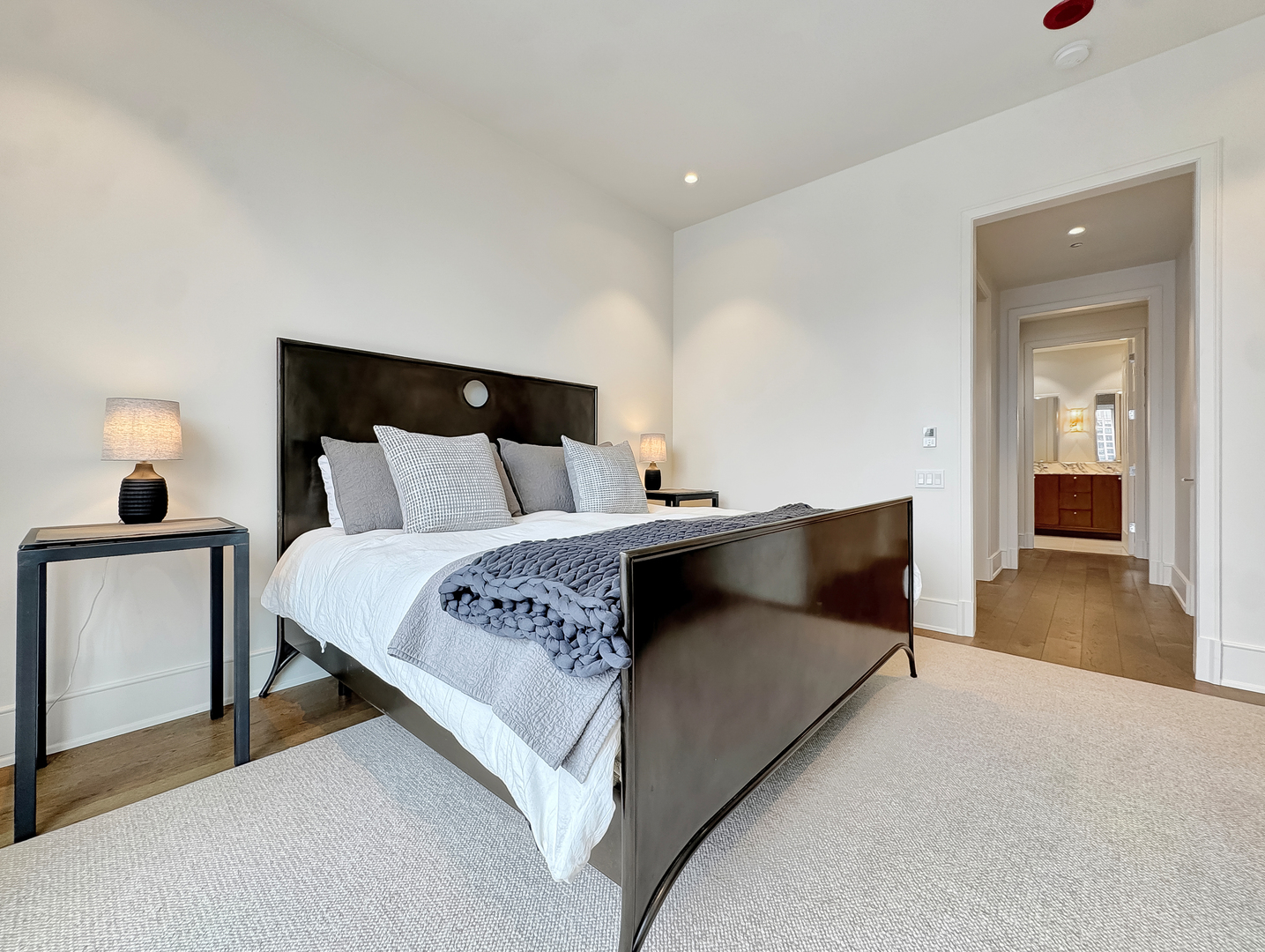 21 North May Street, Unit 802 Chicago, IL 60607 - Photo 21 of 50 a bedroom with a bed and a large mirror