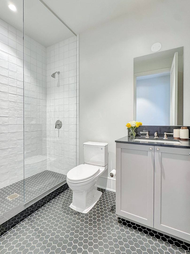 21 North May Street, Unit 802 Chicago, IL 60607 - Photo 35 of 50 a bathroom with a toilet a sink and shower