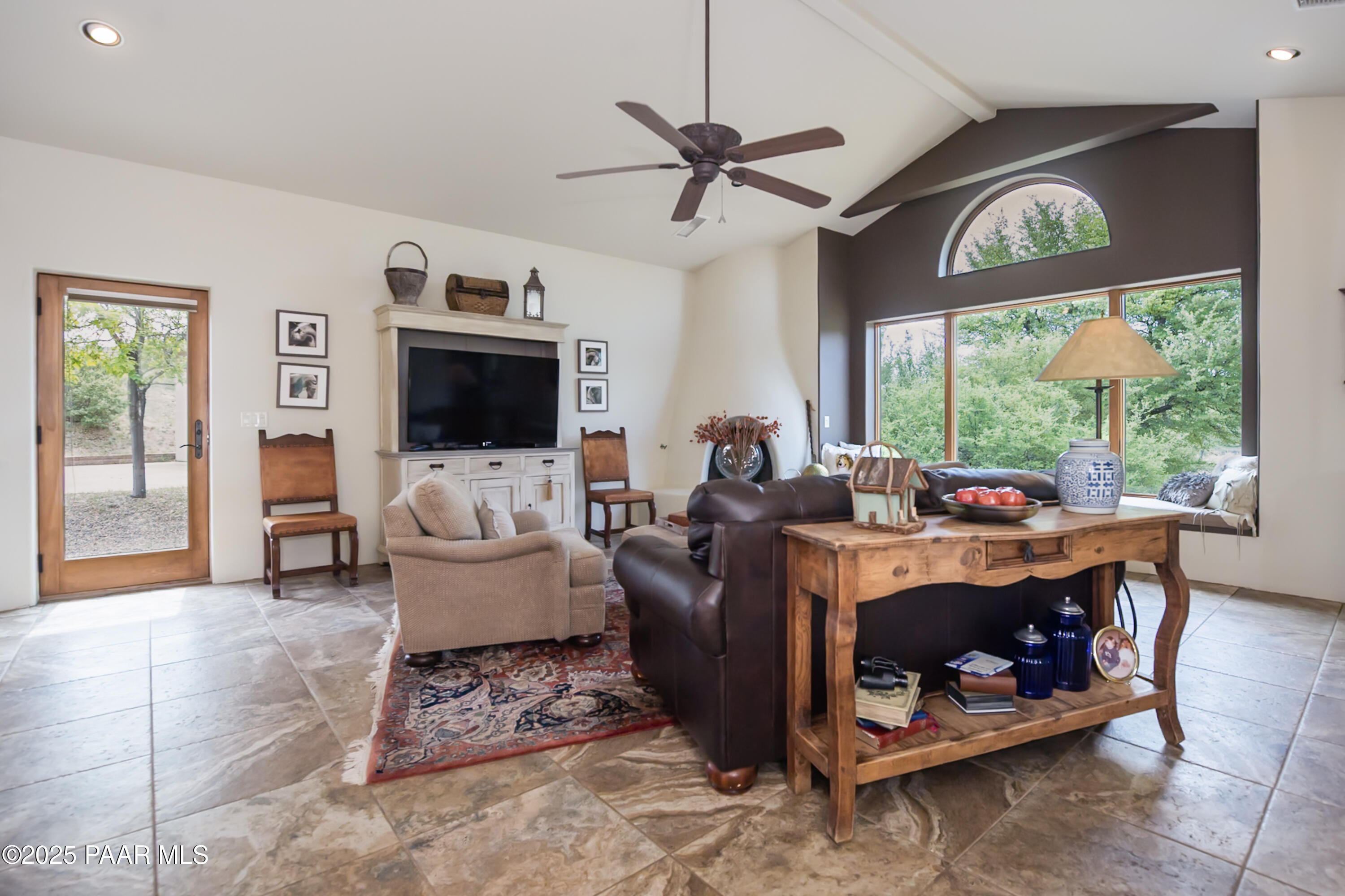 770 Grisby Road Skull Valley, AZ 86338 - Photo 17 of 58 a living room with furniture a flat screen tv and a floor to ceiling window