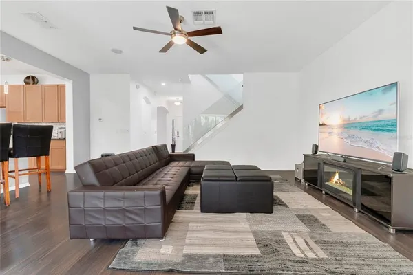 a living room with furniture and wooden floor