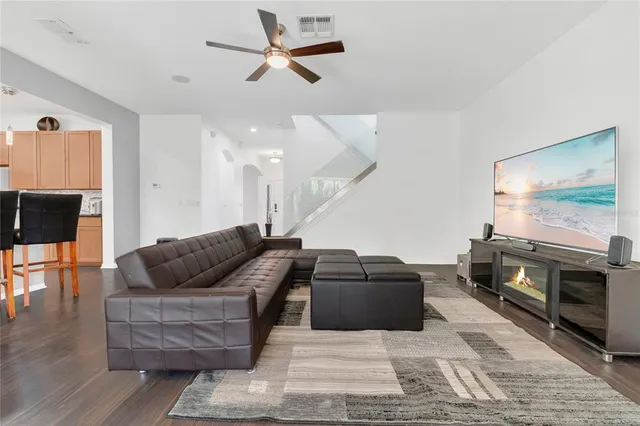 a living room with furniture and wooden floor