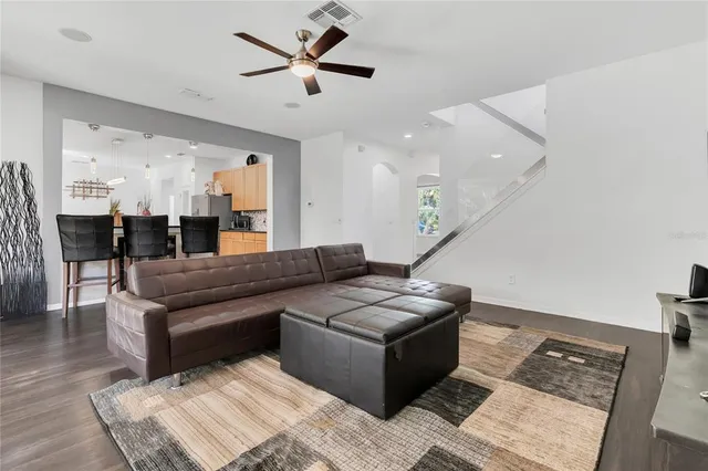 a kitchen with stainless steel appliances granite countertop a stove top oven a sink a dining table and chairs