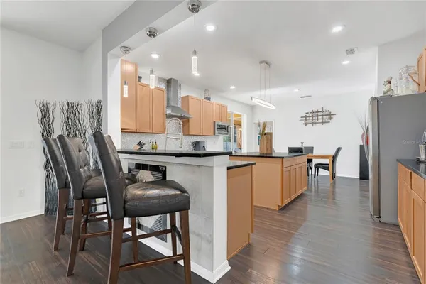 a kitchen with stainless steel appliances granite countertop a sink stove and refrigerator