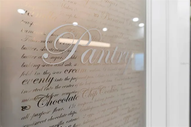 a view of an empty room with wooden floor and a ceiling fan