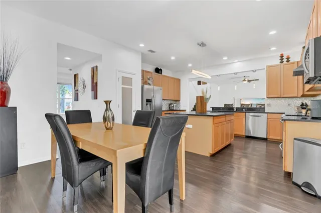 a view of a room with wooden floor and a ceiling fan