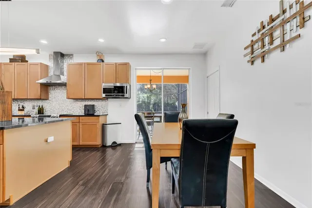 a living room with a large window and a glass door with glass windows