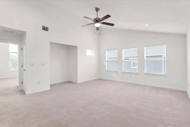 wooden floor in an empty room with a ceiling fan