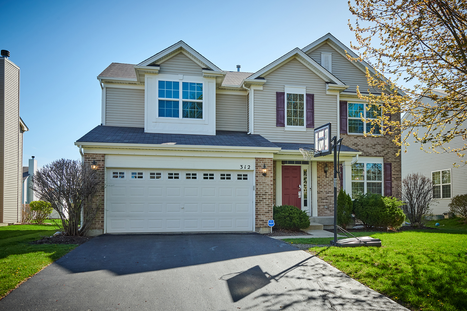 312 Shelbourne Road Volo, IL 60073 - Photo 1 of 54 a front view of a house with a yard and garage