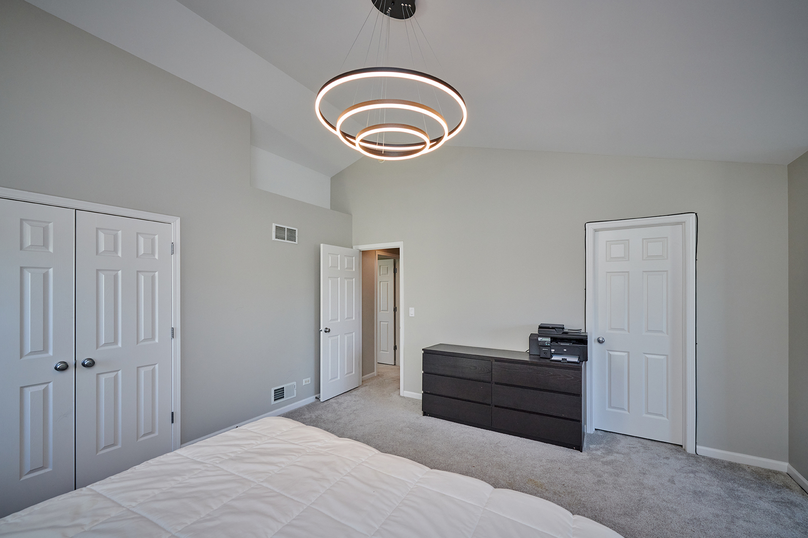 312 Shelbourne Road Volo, IL 60073 - Photo 18 of 54 a bedroom with a bed and a chandelier