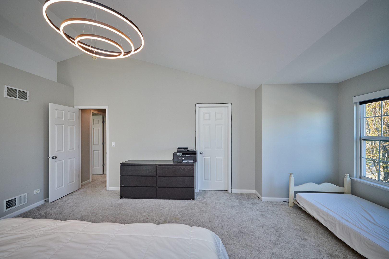 312 Shelbourne Road Volo, IL 60073 - Photo 19 of 54 a living room with a bed and a chandelier