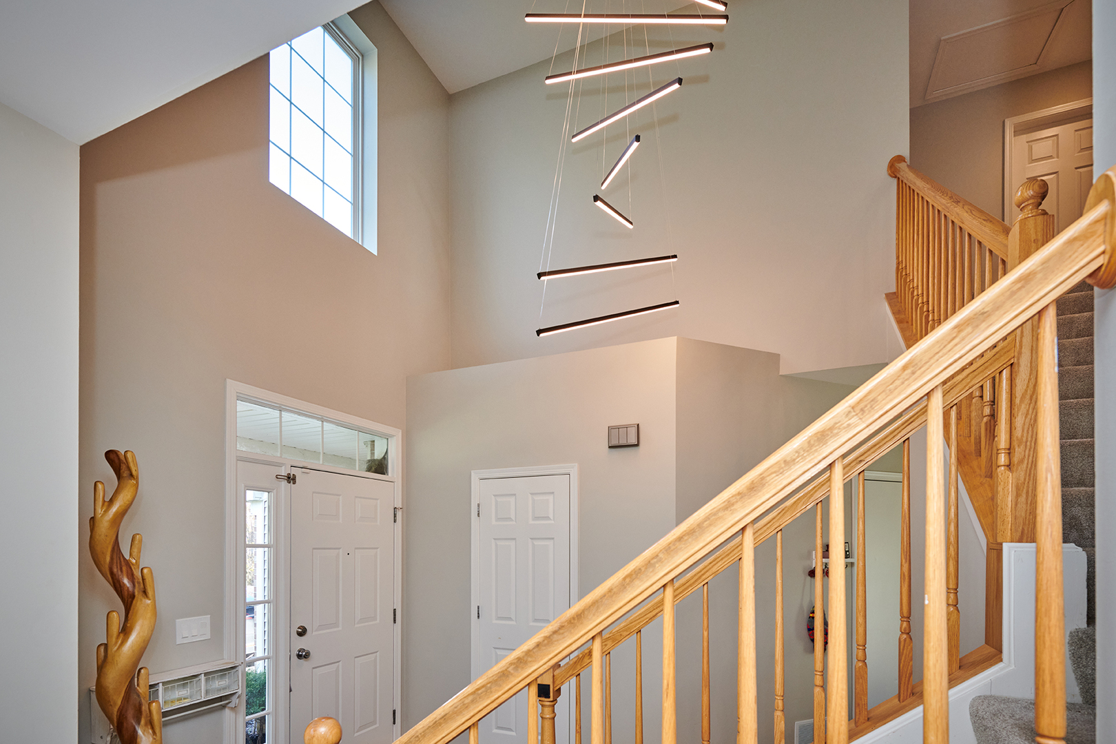 312 Shelbourne Road Volo, IL 60073 - Photo 27 of 54 a view of staircase with railing and a chandelier