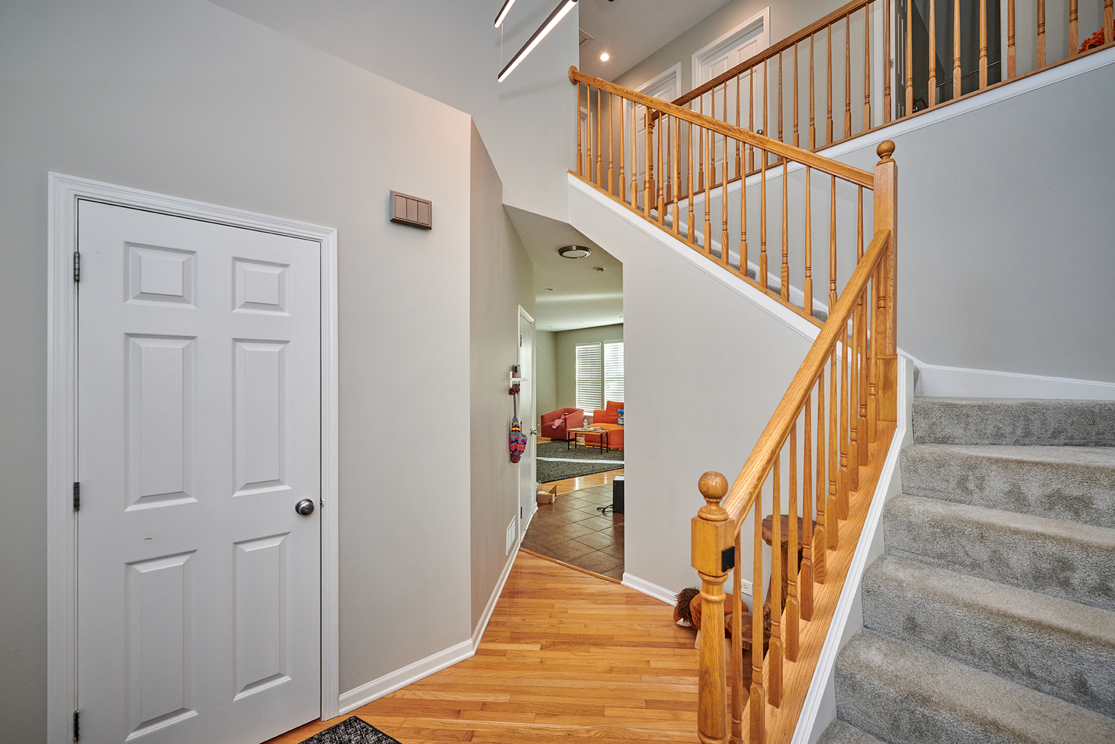 312 Shelbourne Road Volo, IL 60073 - Photo 29 of 54 a view of staircase with lots of frames on wall and wooden floor