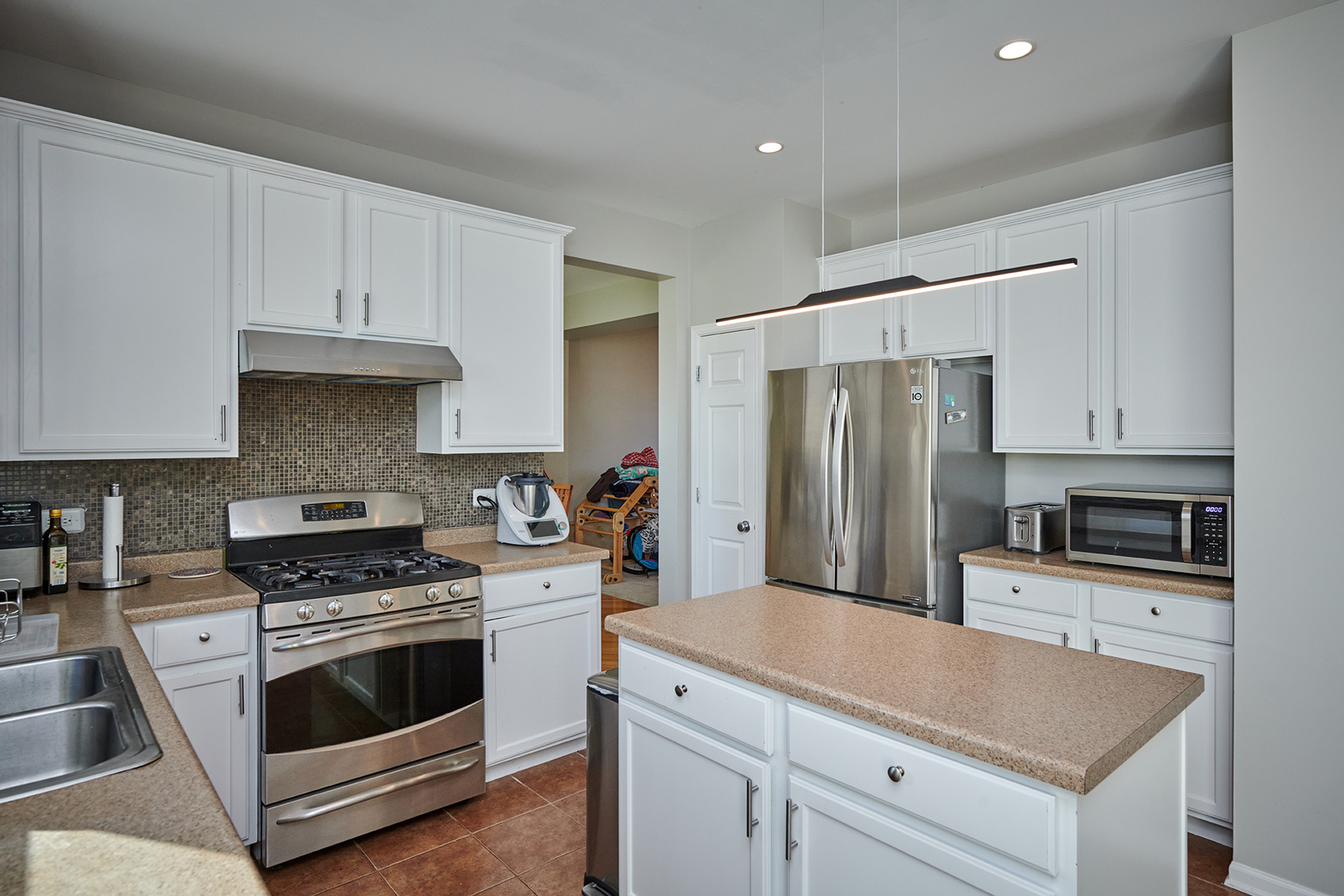 312 Shelbourne Road Volo, IL 60073 - Photo 39 of 54 a kitchen with granite countertop a stove sink and refrigerator
