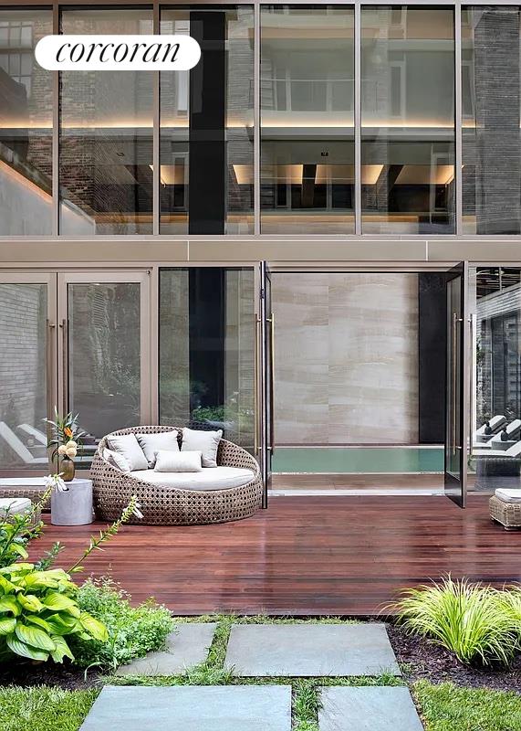 505-513 West 43rd Street, Unit 5J Manhattan, NY 10036 - Photo 15 of 17 a front view of a house with a yard