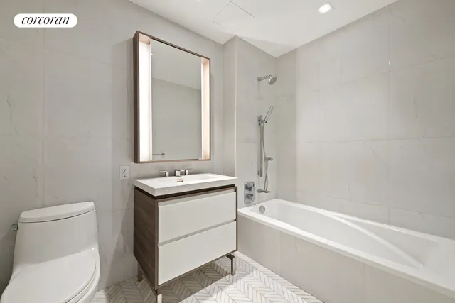 a bathroom with a sink toilet and tub