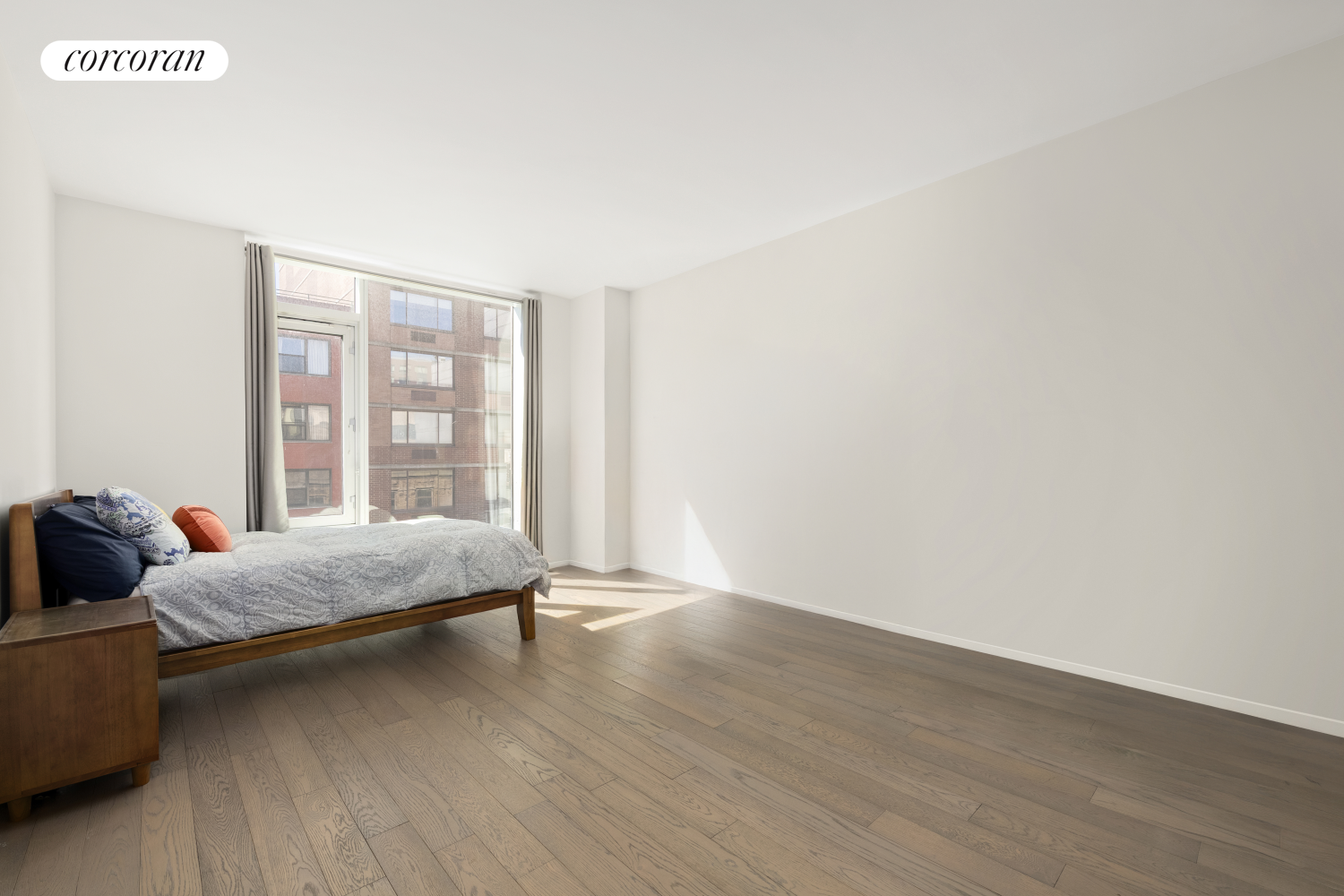 505-513 West 43rd Street, Unit 5J Manhattan, NY 10036 - Photo 4 of 17 a living room with furniture and wooden floor