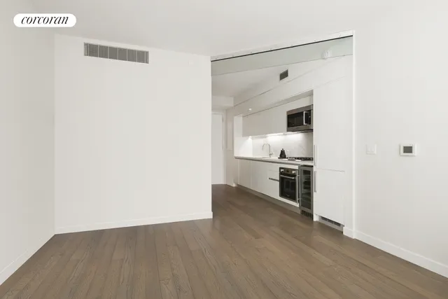 a view of a kitchen with a stove wooden floor and a refrigerator