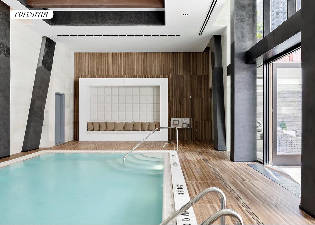 505-513 West 43rd Street, Unit 5J Manhattan, NY 10036 - Photo 10 of 17 a bedroom with a bed and a large window