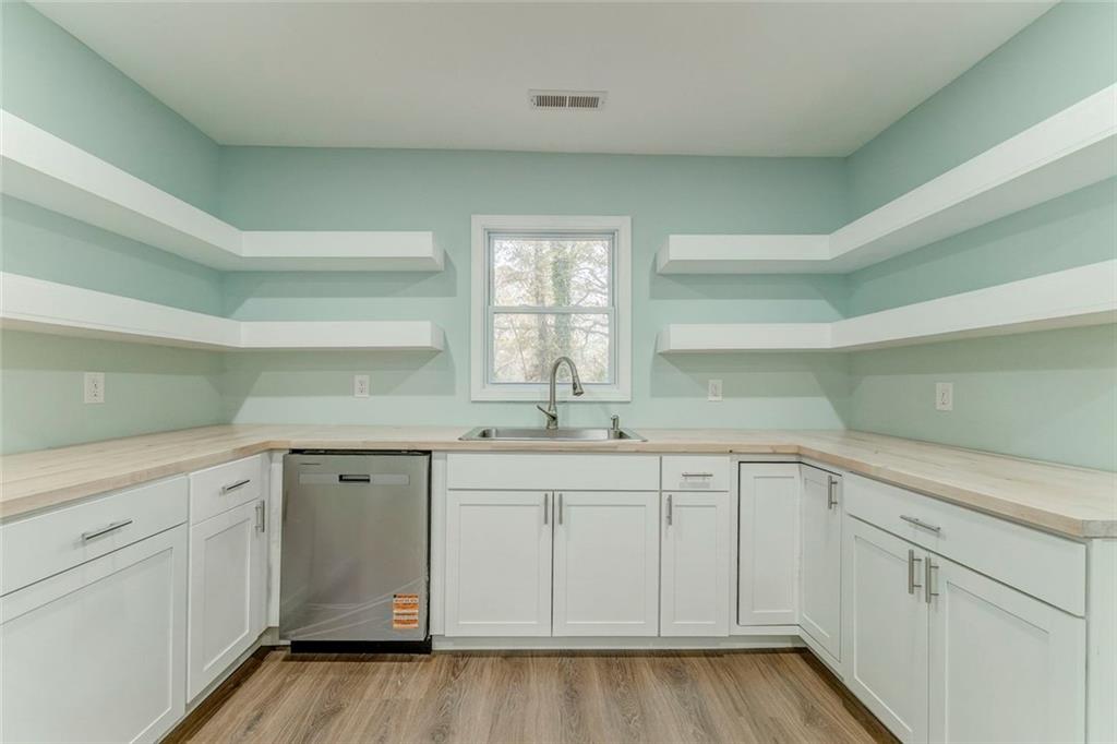 43 King Bee Circle Rome, GA 30161 - Photo 11 of 47 a kitchen with white cabinets and sink