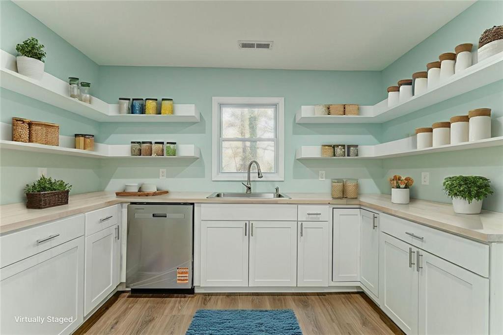 43 King Bee Circle Rome, GA 30161 - Photo 12 of 47 a kitchen with cabinets a sink and wooden floor
