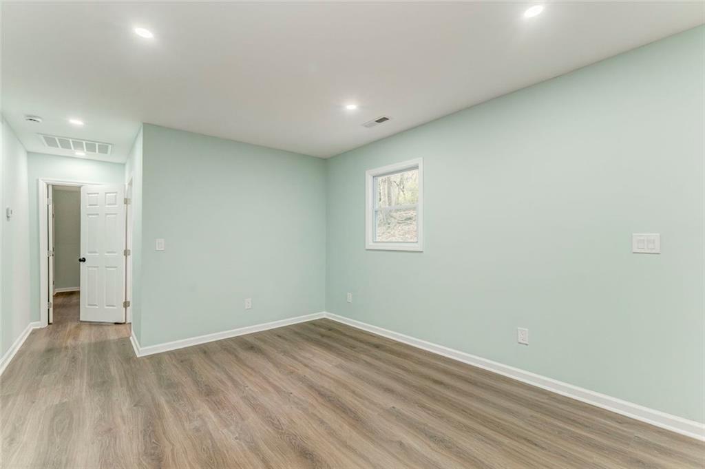 43 King Bee Circle Rome, GA 30161 - Photo 15 of 47 an empty room with wooden floor and windows