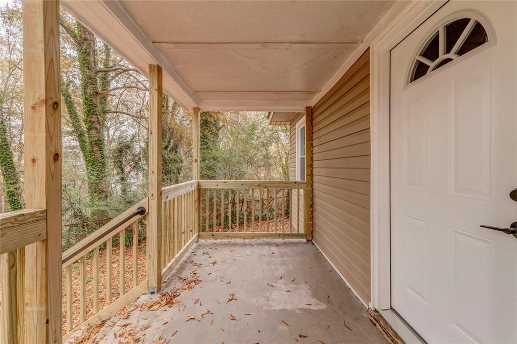 43 King Bee Circle Rome, GA 30161 - Photo 2 of 47 a view of a porch with wooden floor and iron fence