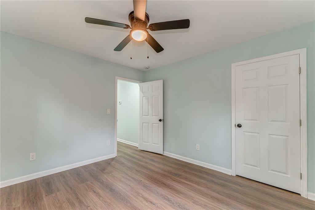 43 King Bee Circle Rome, GA 30161 - Photo 22 of 47 an empty room with wooden floor ceiling fan and windows