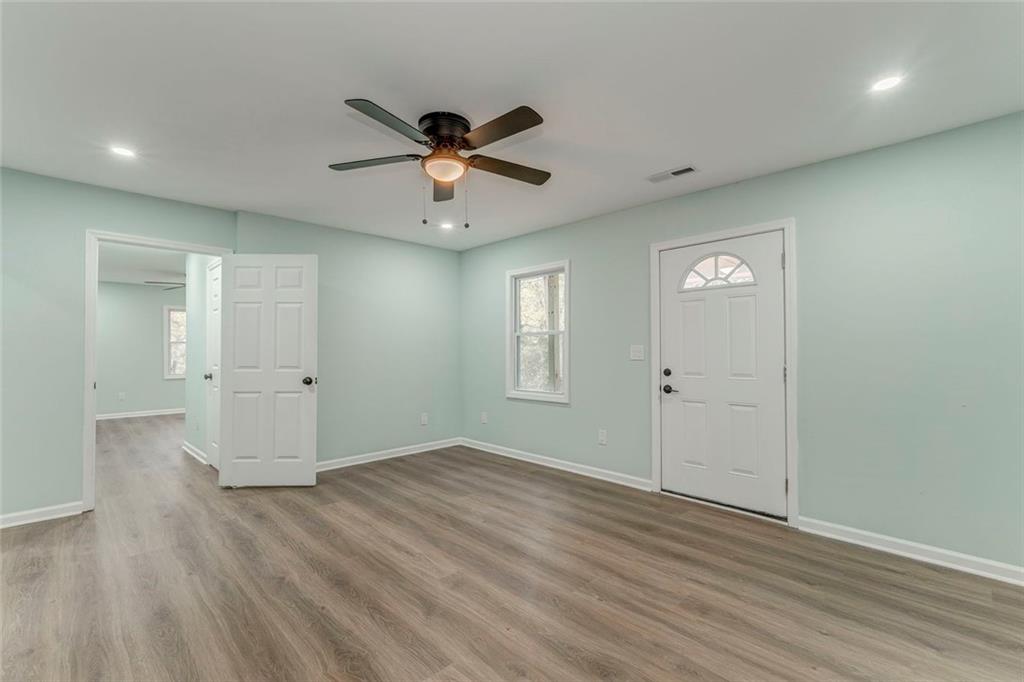 43 King Bee Circle Rome, GA 30161 - Photo 25 of 47 an empty room with wooden floor and ceiling fan