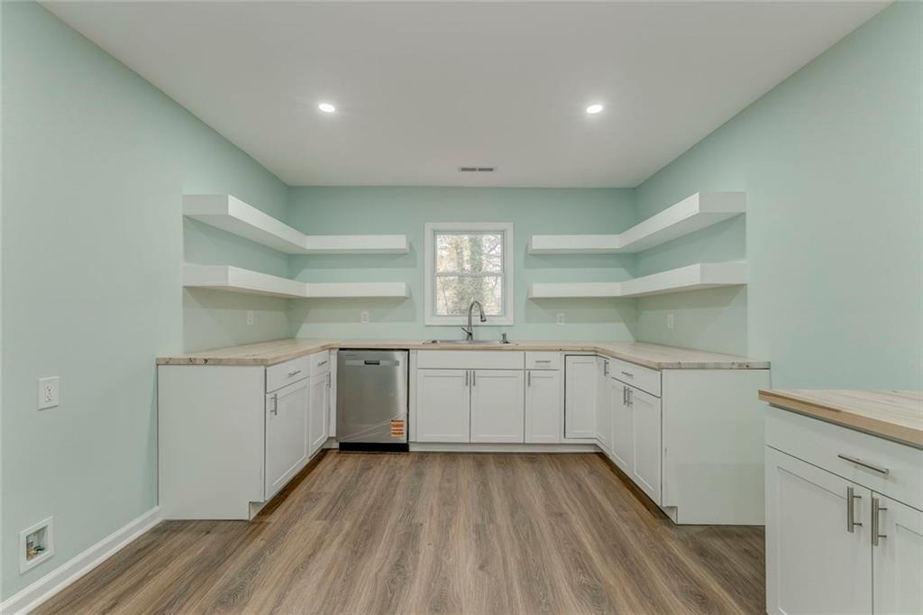 43 King Bee Circle Rome, GA 30161 - Photo 8 of 47 a kitchen with cabinets and wooden floor