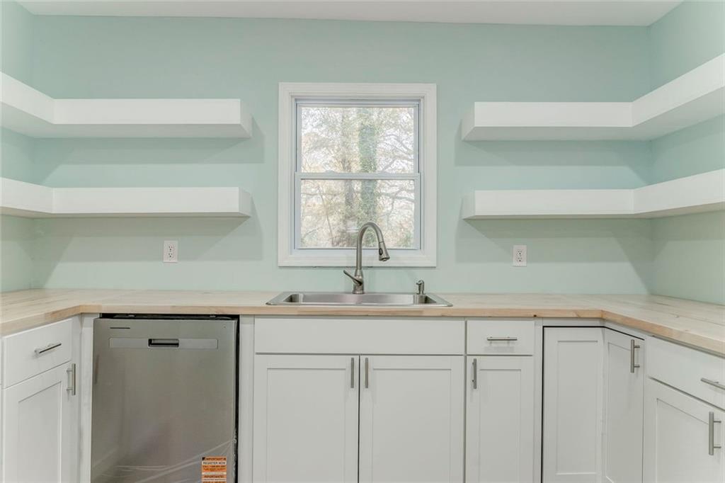 43 King Bee Circle Rome, GA 30161 - Photo 10 of 47 a kitchen with a sink and cabinets