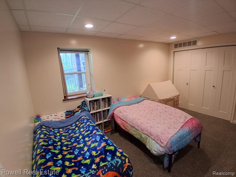 6807 Big Trail Road Holly, MI 48442 - Photo 31 of 45 Carpeted room featuring a single window with a wood sill, recessed ceiling lights, and two large bifold closet doors