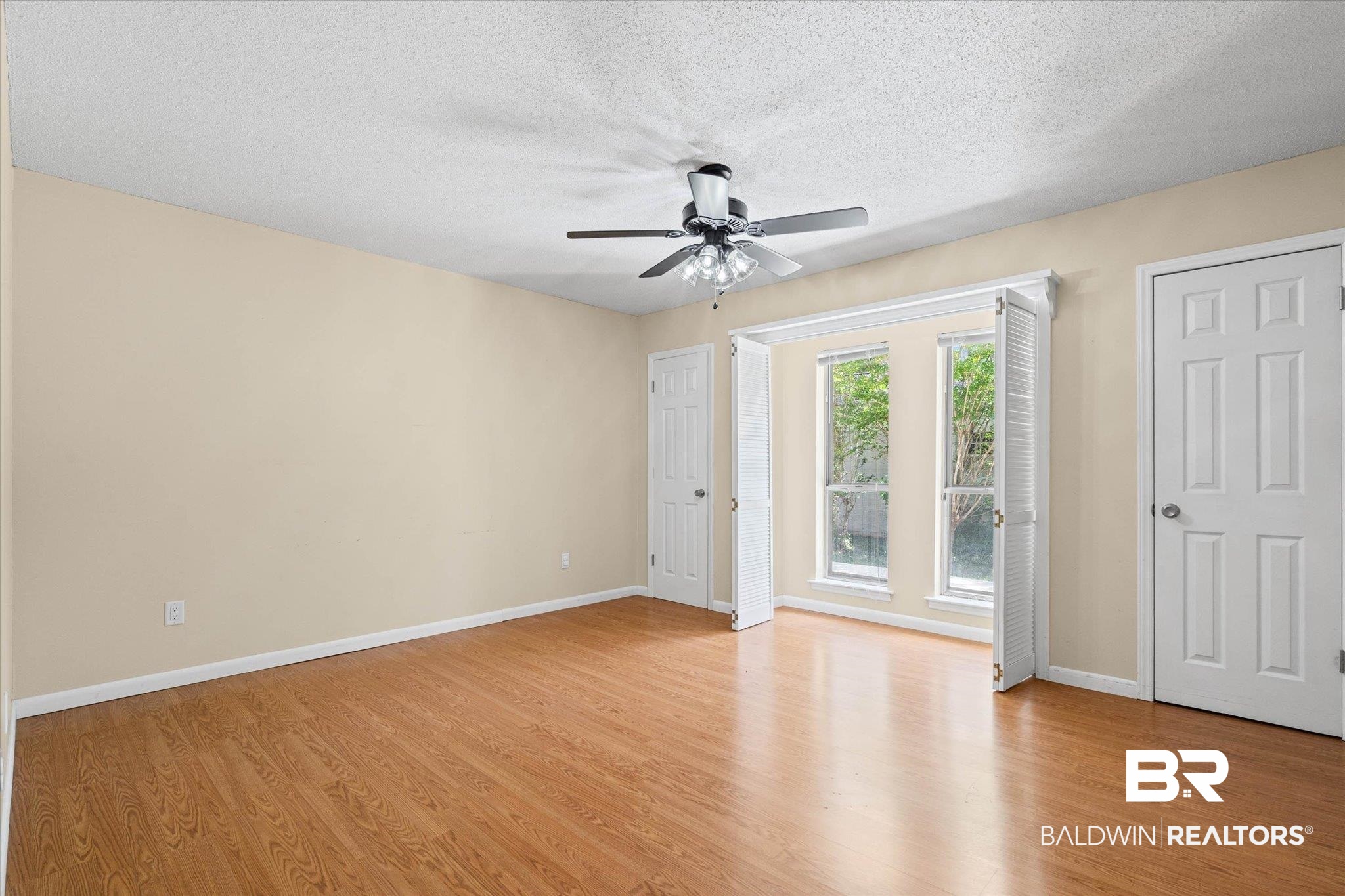 3724 Claridge Road South Mobile, AL 36608 - Photo 26 of 42 Empty room featuring light wood-type flooring, a ceiling fan, and a textured ceiling