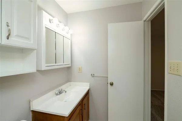 a bathroom with a sink a vanity and a mirror